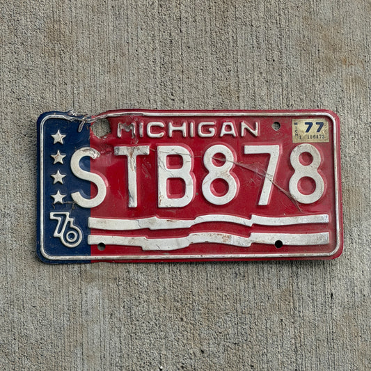Photo of a 1976 1977 Michigan License Plate Auto Tag Garage Decor Vintage Bicentennial STB 878 with original patina