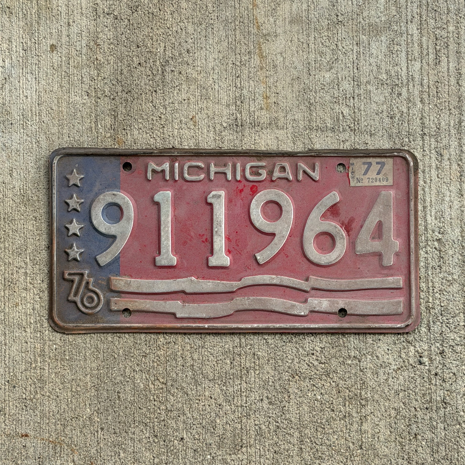 Photo of a 1976 1977 Michigan Trailer License Plate Auto Tag Garage Decor Vintage Bicentennial 911 964 with original patina