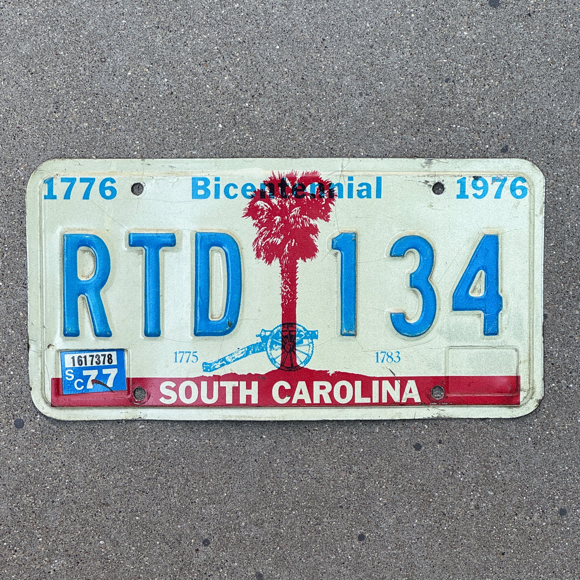 Photo of a 1976 1977 South Carolina License Plate Auto Tag Garage Decor Vintage Bicentennial RTD 134 with original patina