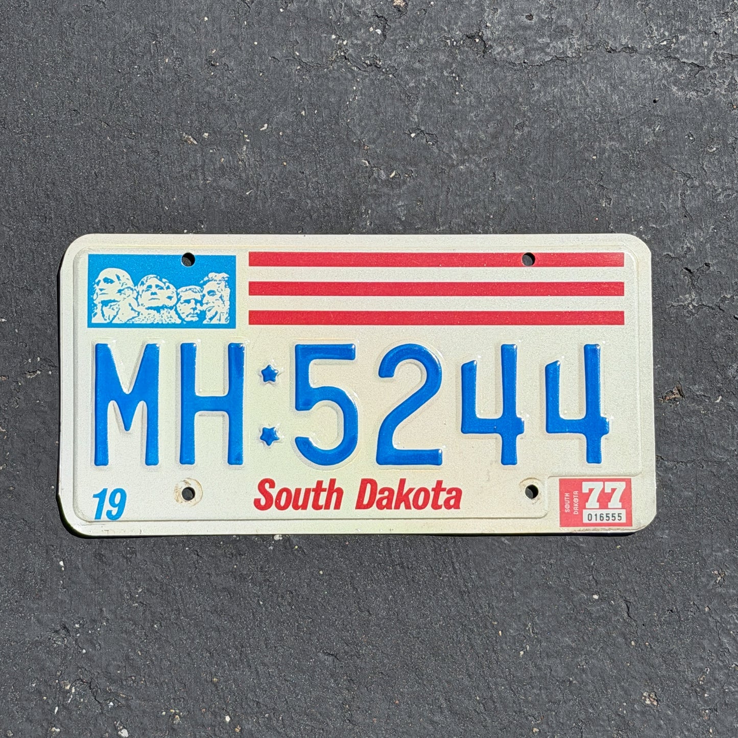 Photo of a 1976 1977 South Dakota License Plate Auto Tag 2 Vintage Garage MH 5244 with original patina