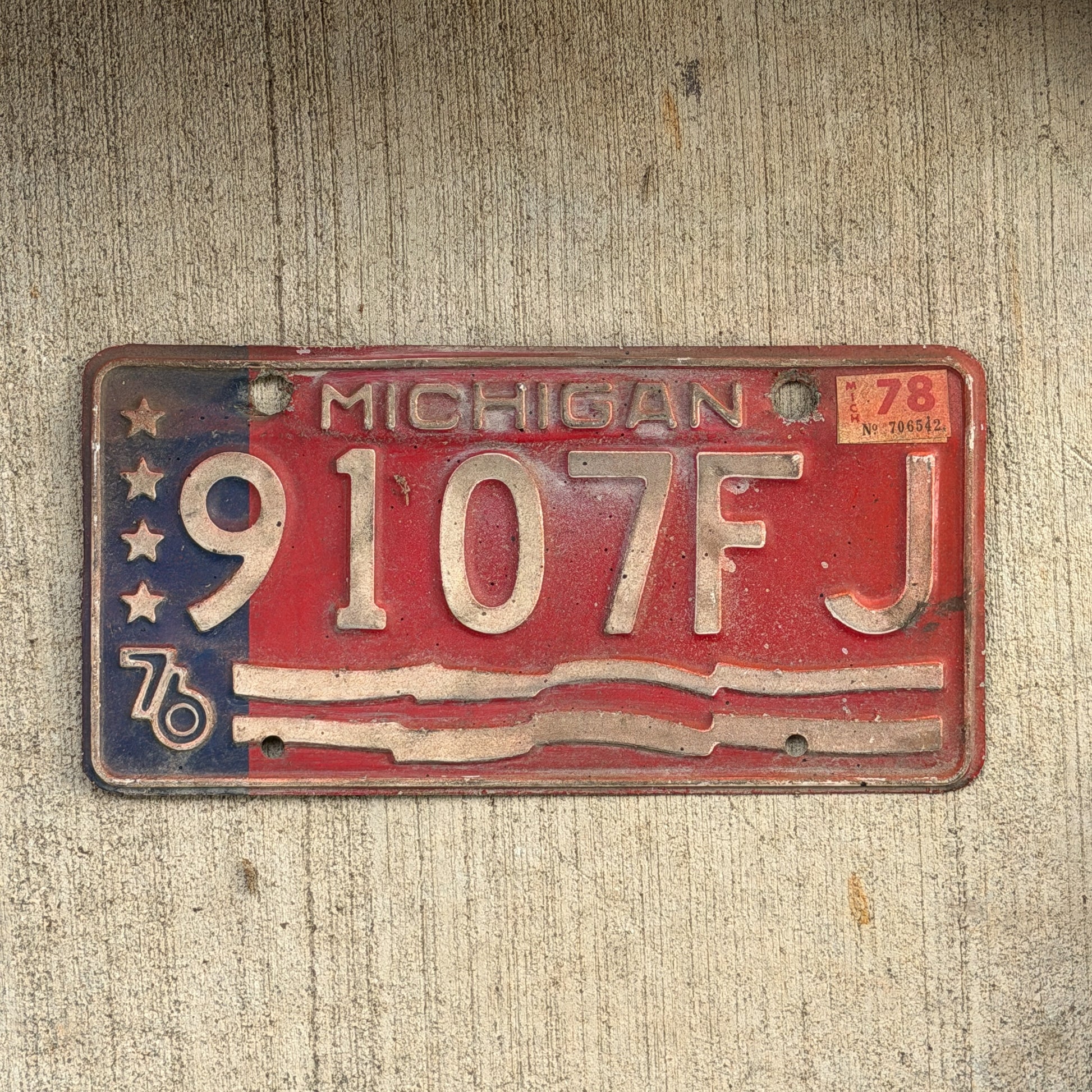 Photo of a 1976 1978 Michigan Commercial License Plate Auto Tag Garage Decor Vintage Bicentennial 9107 FJ with original patina