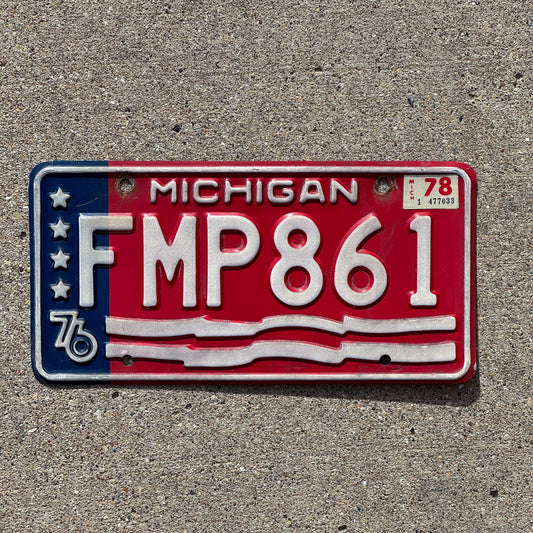 Photo of a 1976 1978 Michigan License Plate Auto Tag 1 Vintage Garage American Flag Bicentennial FMP 861 with original patina