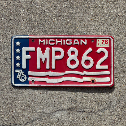 Photo of a 1976 1978 Michigan License Plate Auto Tag 2 Vintage Garage American Flag Bicentennial FMP 862 with original patina