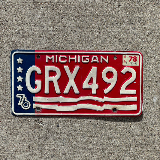 Photo of a 1976 1978 Michigan License Plate Auto Tag Garage Decor Vintage American Flag Bicentennial GRX 492 with original patina