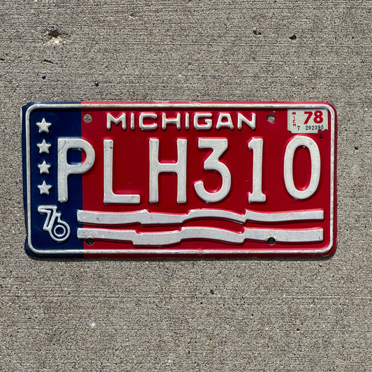 Photo of a 1976 1978 Michigan License Plate Auto Tag Garage Decor Vintage American Flag Bicentennial PLH 310 with original patina
