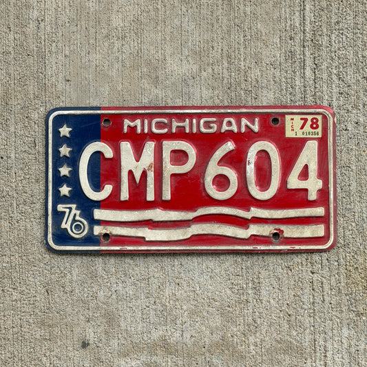 Photo of a 1976 1978 Michigan License Plate Auto Tag Garage Decor Vintage Bicentennial CMP 604 with original patina