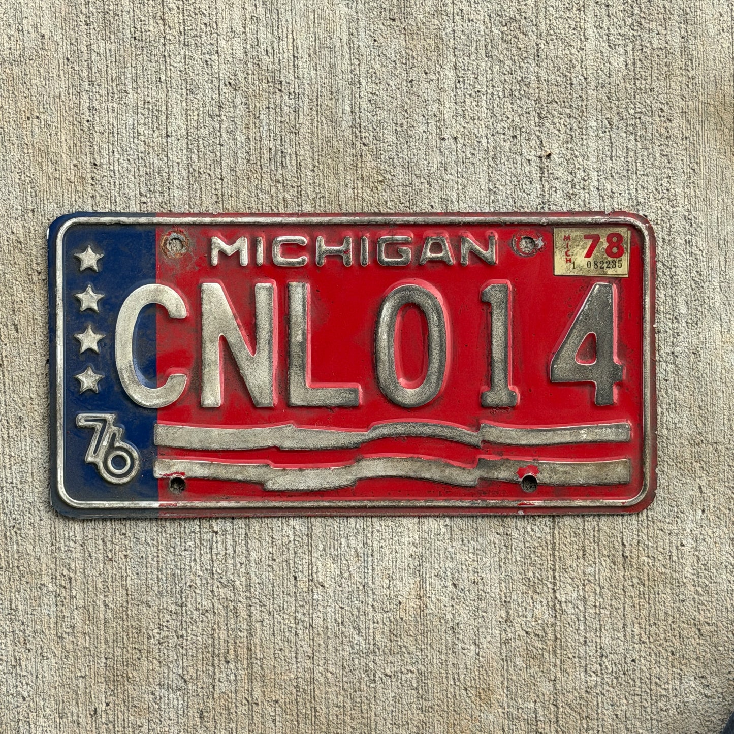 Photo of a 1976 1978 Michigan License Plate Auto Tag Garage Decor Vintage Bicentennial CNL 014 with original patina
