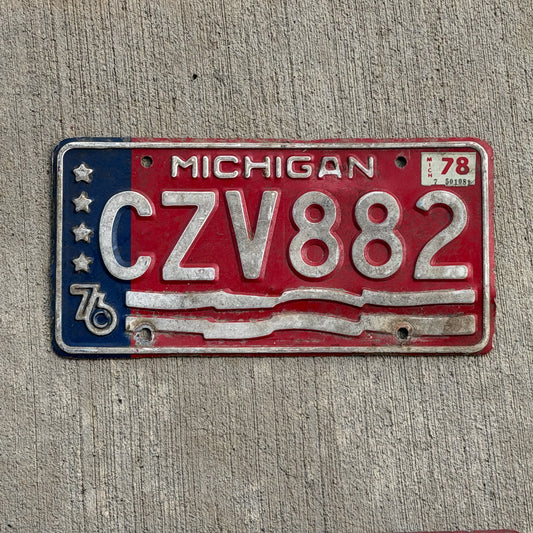 Photo of a 1976 1978 Michigan License Plate Auto Tag Garage Decor Vintage Bicentennial CZV 882 with original patina