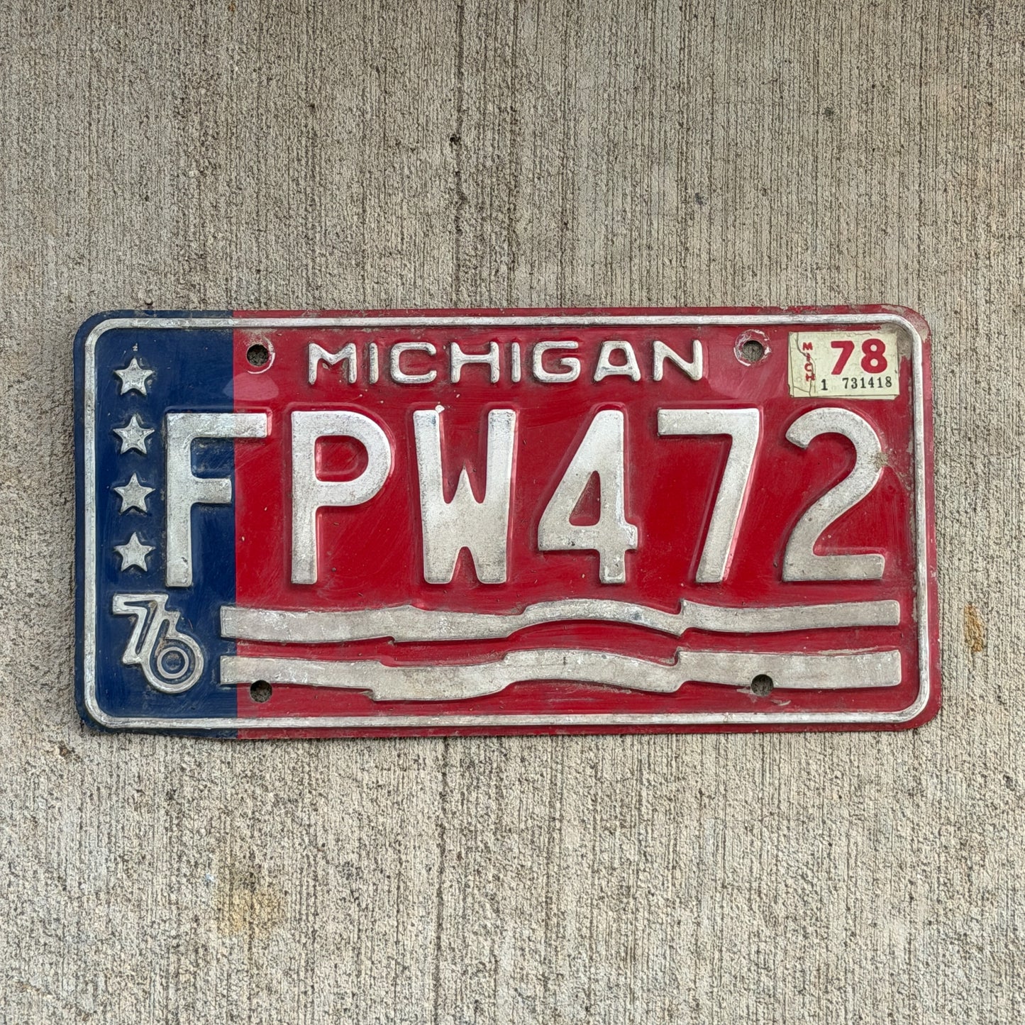 Photo of a 1976 1978 Michigan License Plate Auto Tag Garage Decor Vintage Bicentennial FPW 472 with original patina