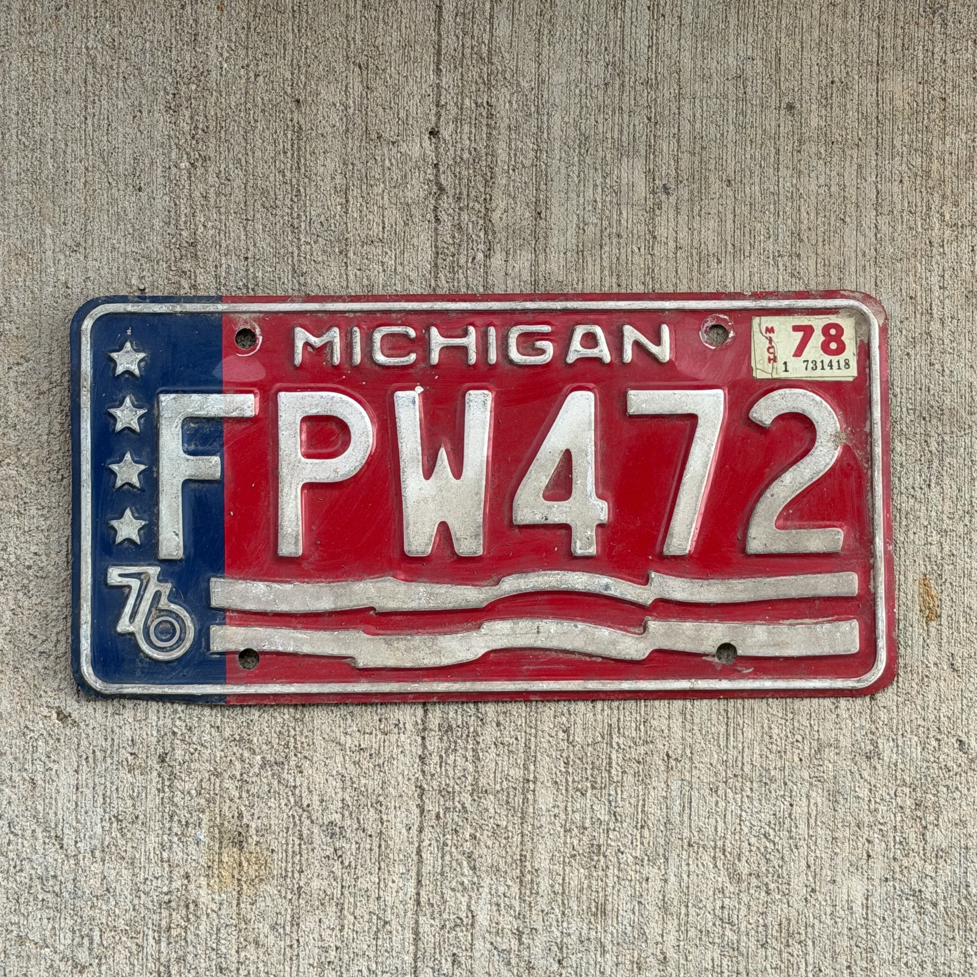 Photo of a 1976 1978 Michigan License Plate Auto Tag Garage Decor Vintage Bicentennial FPW 472 with original patina