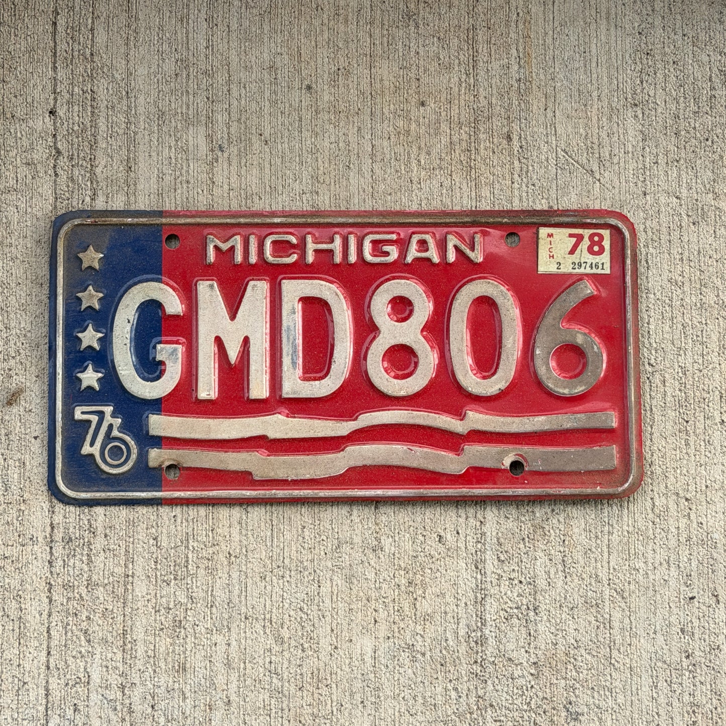 Photo of a 1976 1978 Michigan License Plate Auto Tag Garage Decor Vintage Bicentennial GMD 806 with original patina