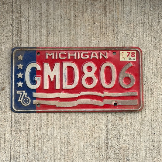 Photo of a 1976 1978 Michigan License Plate Auto Tag Garage Decor Vintage Bicentennial GMD 806 with original patina