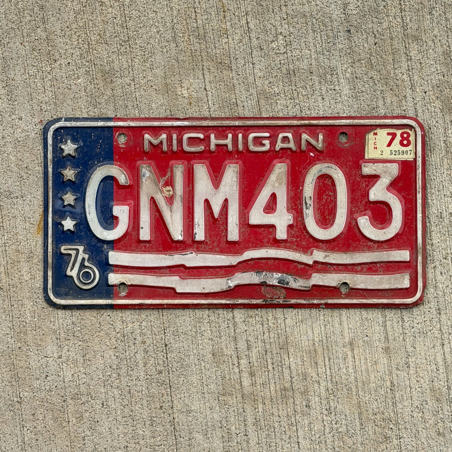 Photo of a 1976 1978 Michigan License Plate Auto Tag Garage Decor Vintage Bicentennial GNM 403 with original patina