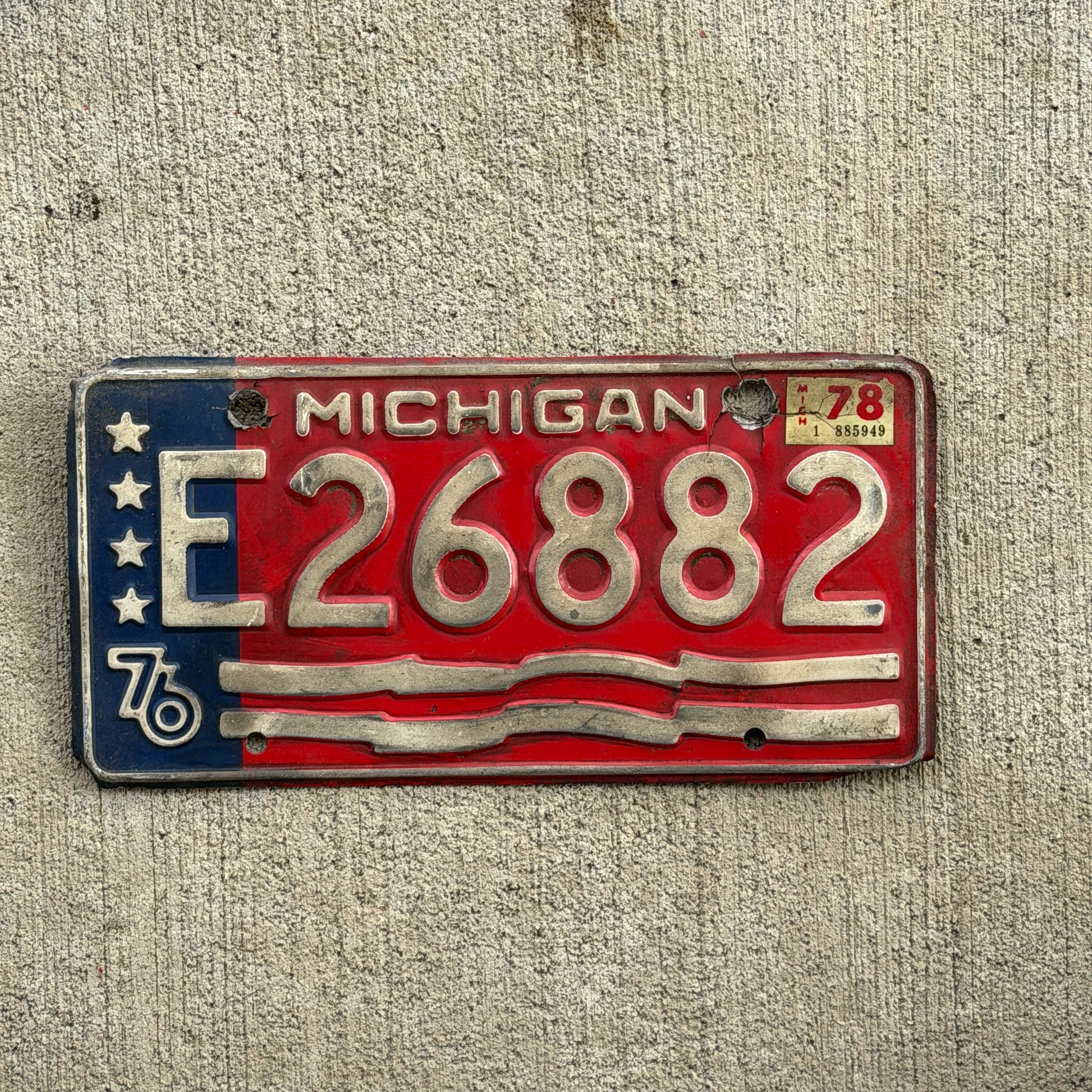 Photo of a 1976 1978 Michigan Trailer License Plate Auto Tag Garage Decor Vintage Bicentennial E 26882 with original patina