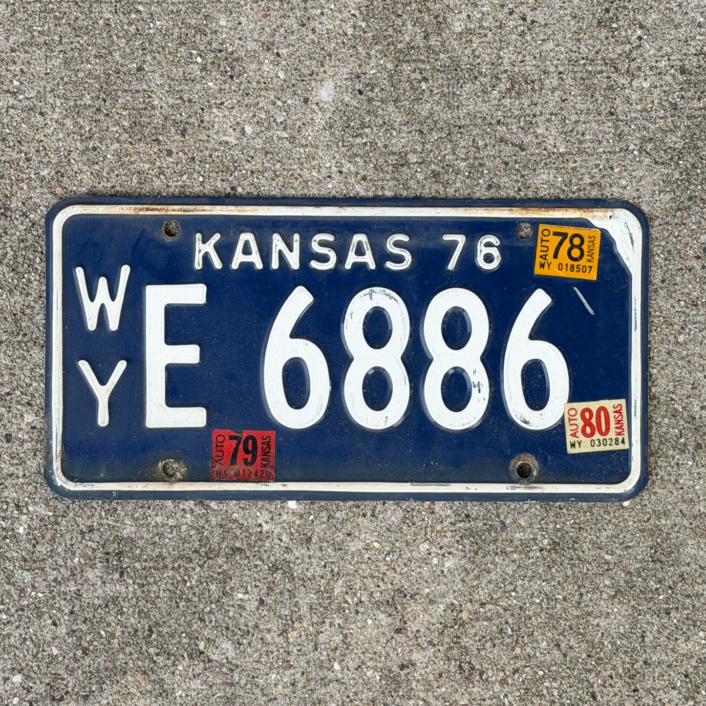 Photo of a 1976 1980 Kansas License Plate Auto Tag Garage Decor Vintage WY E 6886 with original patina