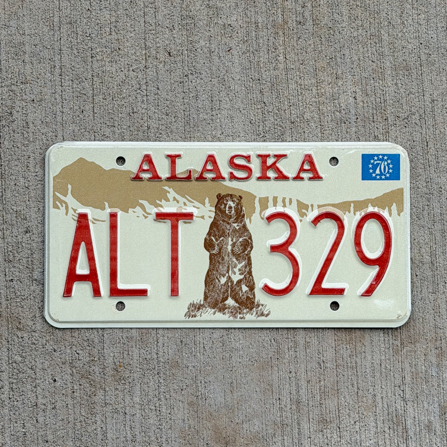 Photo of a 1976 Alaska License Plate Auto Tag 1 Vintage Garage Bicentennial Bear ALT 329 with original patina