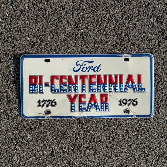 Photo of a 1976 Booster License Plate Auto Tag Garage Decor Vintage Ford Bicentennial Year Metal