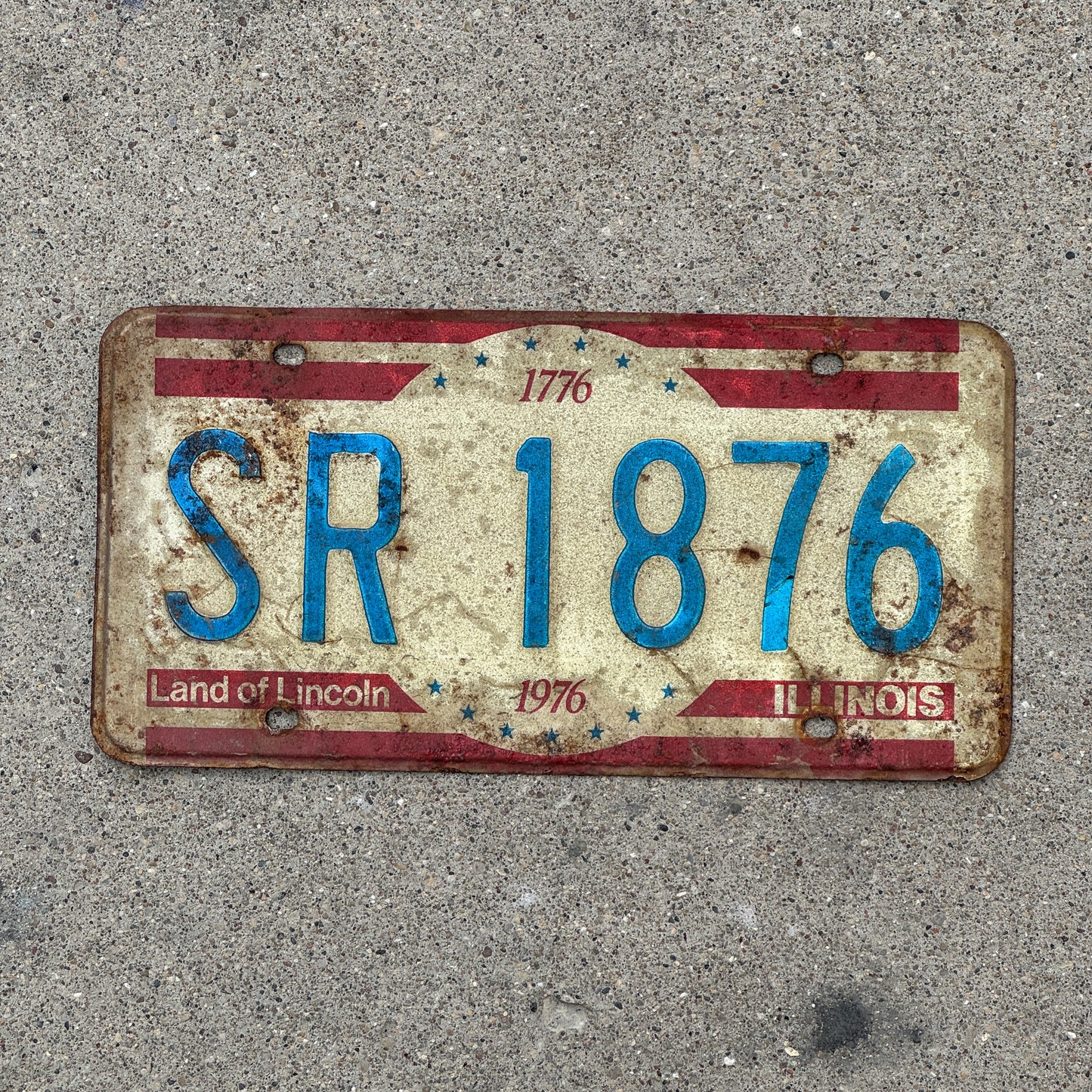 Photo of a 1976 Illinois License Plate Auto Tag Garage Decor Vintage Bicentennial SR 1876 with original patina