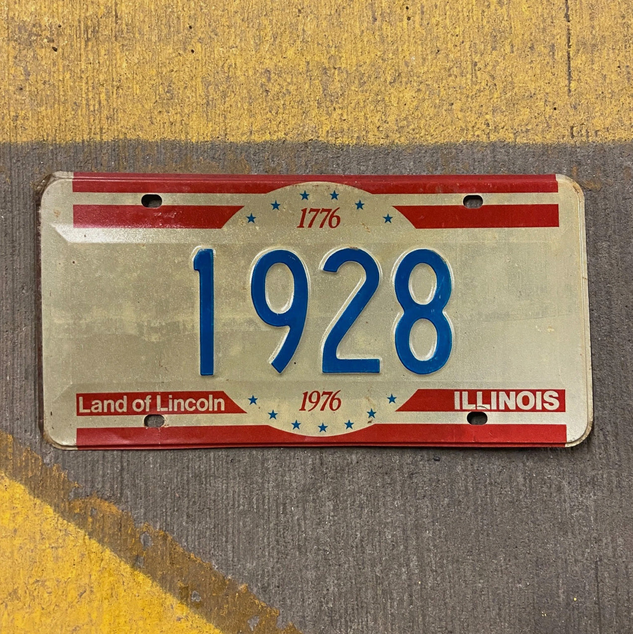 Photo of a 1976 Illinois License Plate Auto Tag Garage Decor Vintage Low Number Four Digit 1928 with original patina