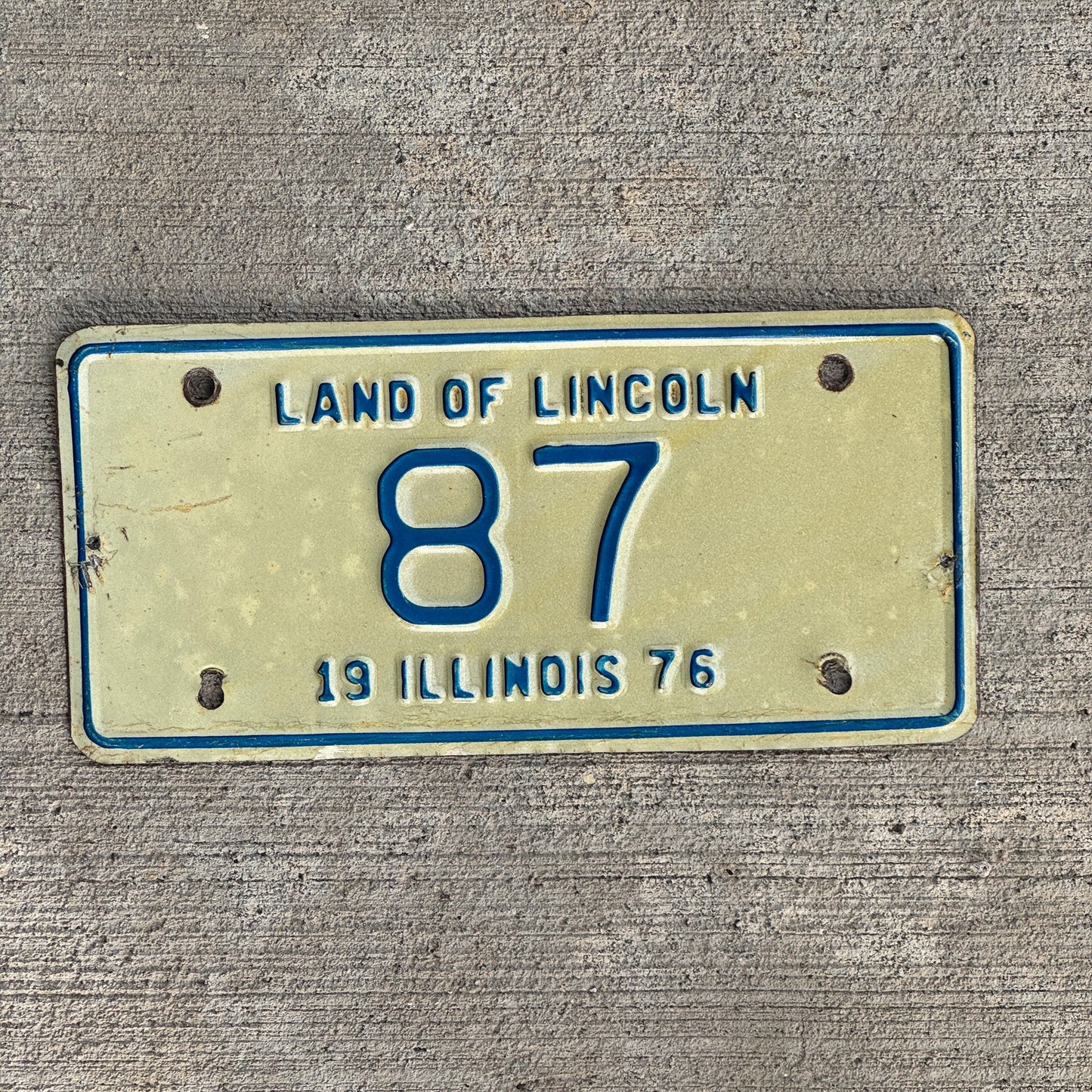 Photo of a 1976 Illinois Motorcycle License Plate Auto Tag Garage Decor Vintage Low Number Two Digit 87 with original patina