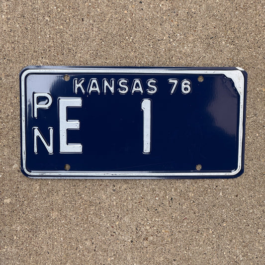 Photo of a 1976 Kansas License Plate Auto Tag Garage Decor Vintage Number One Low Number PN E 1 with original patina
