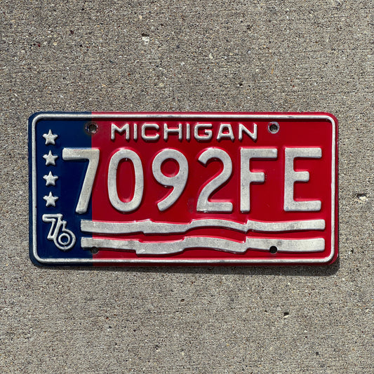 Photo of a 1976 Michigan Commercial License Plate Auto Tag Garage Decor Vintage American Flag Bicentennial 7092 FE with original patina