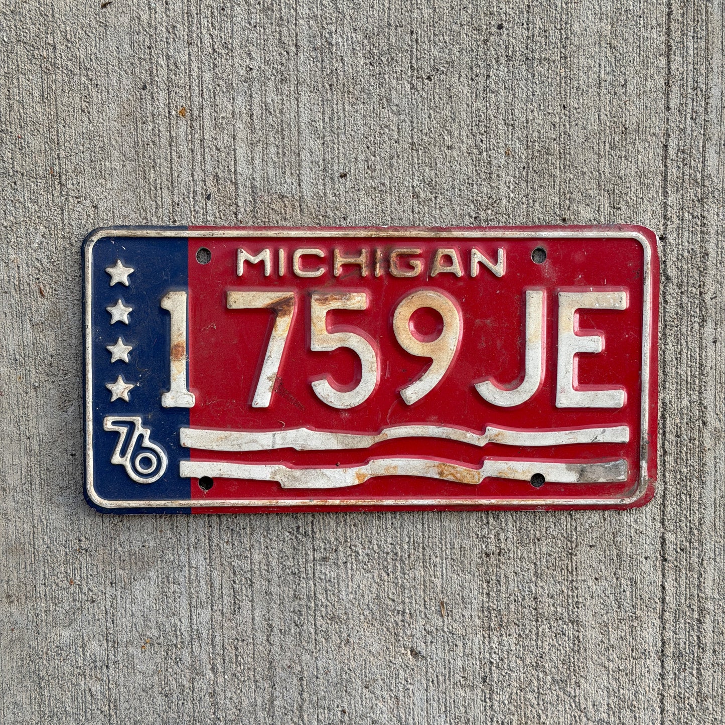 Photo of a 1976 Michigan Commercial License Plate Auto Tag Garage Decor Vintage Bicentennial 1759 JE with original patina