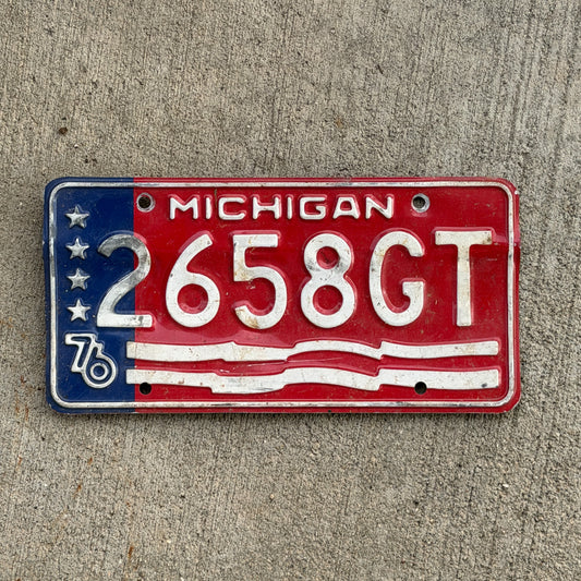 Photo of a 1976 Michigan Commercial License Plate Auto Tag Garage Decor Vintage Bicentennial 2658 GT with original patina