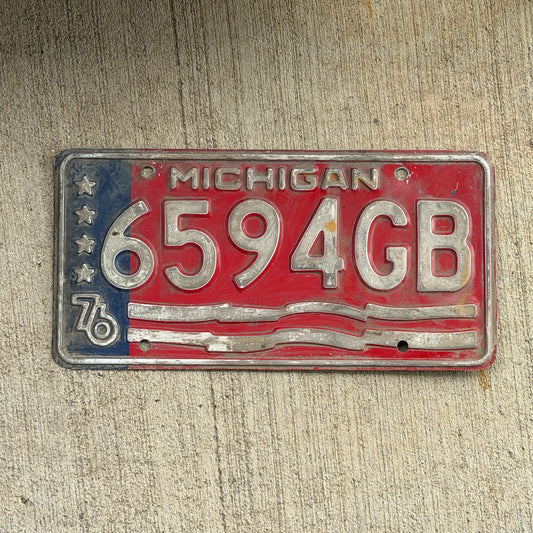 Photo of a 1976 Michigan Commercial License Plate Auto Tag Garage Decor Vintage Bicentennial 6594 GB with original patina