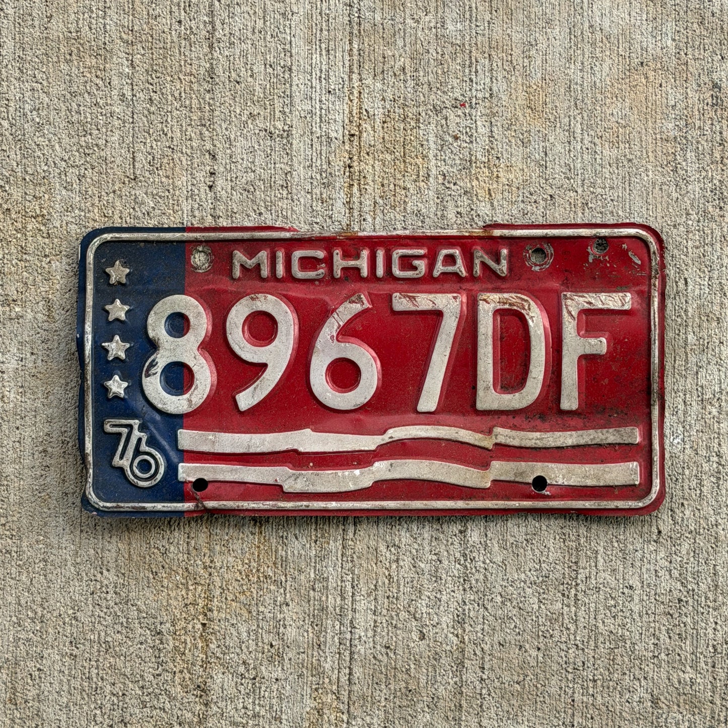 Photo of a 1976 Michigan Commercial License Plate Auto Tag Garage Decor Vintage Bicentennial 8967 DF with original patina