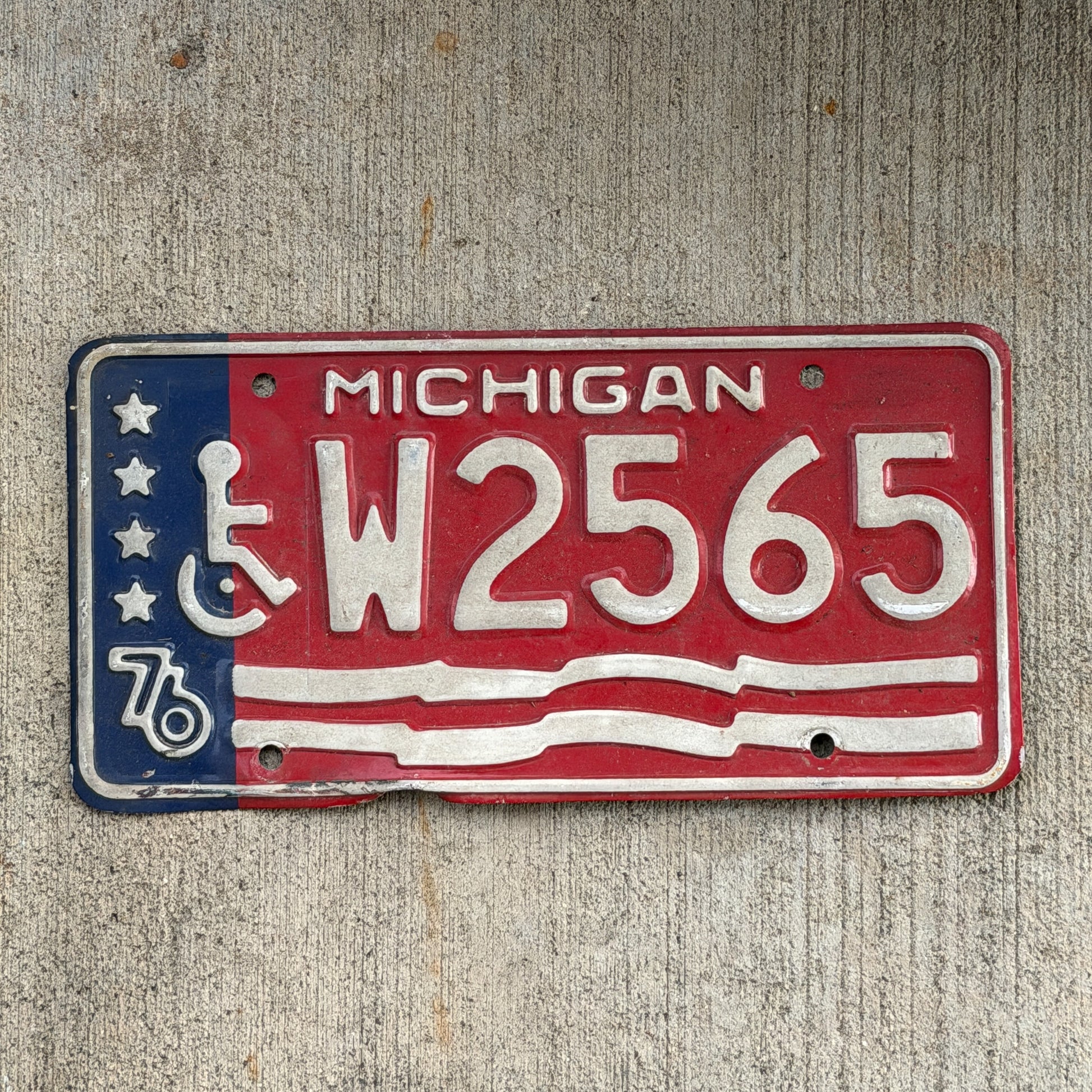 Photo of a 1976 Michigan Handicap License Plate Auto Tag Garage Decor Vintage Bicentennial W 2565 with original patina