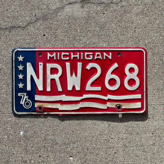 Photo of a 1976 Michigan License Plate Auto Tag Garage Decor Vintage American Flag Bicentennial NRW 268 with original patina