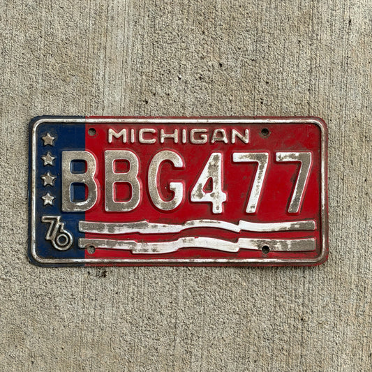 Photo of a 1976 Michigan License Plate Auto Tag Garage Decor Vintage Bicentennial BBG 477 with original patina