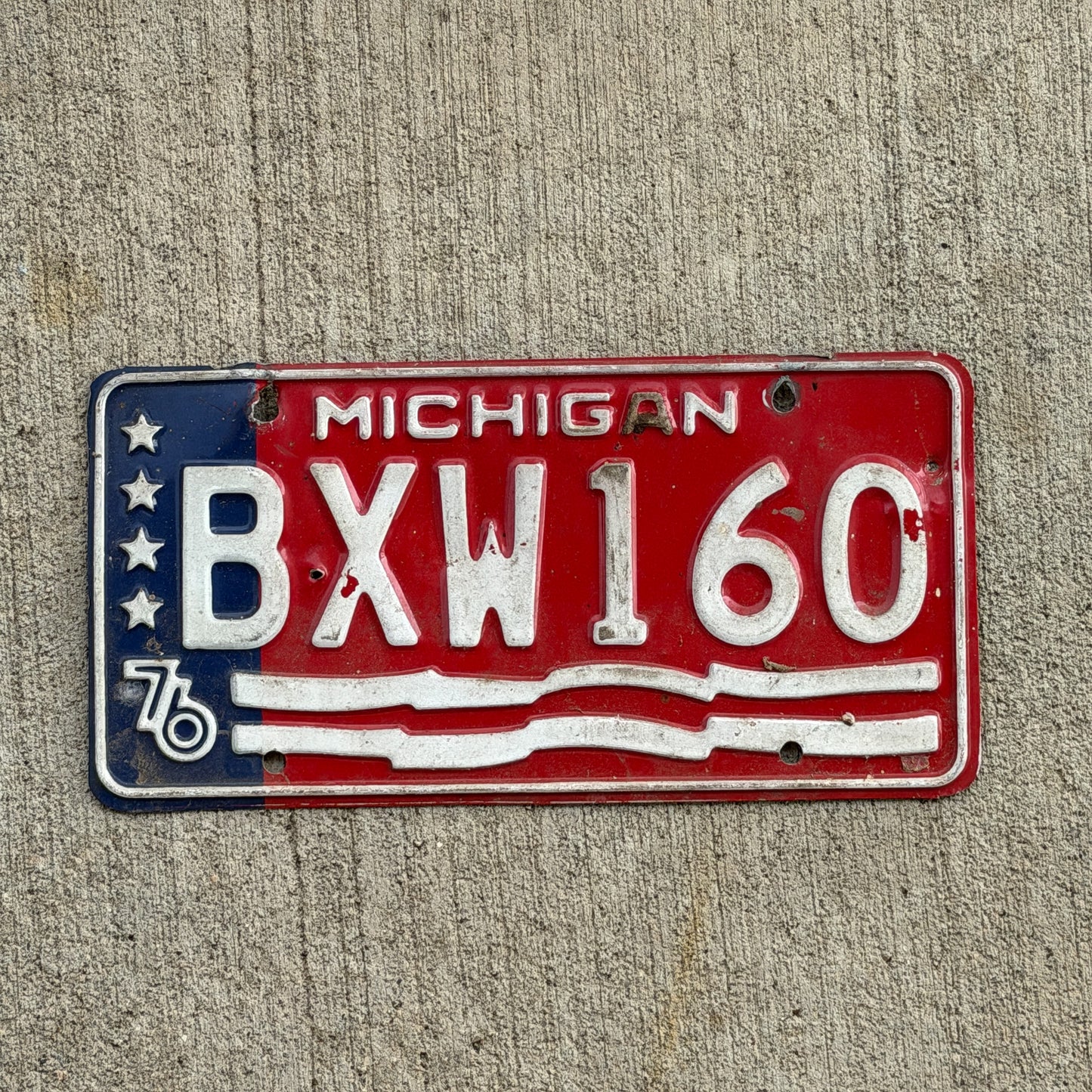 Photo of a 1976 Michigan License Plate Auto Tag Garage Decor Vintage Bicentennial BXW 160 with original patina