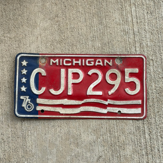 Photo of a 1976 Michigan License Plate Auto Tag Garage Decor Vintage Bicentennial CJP 295 with original patina