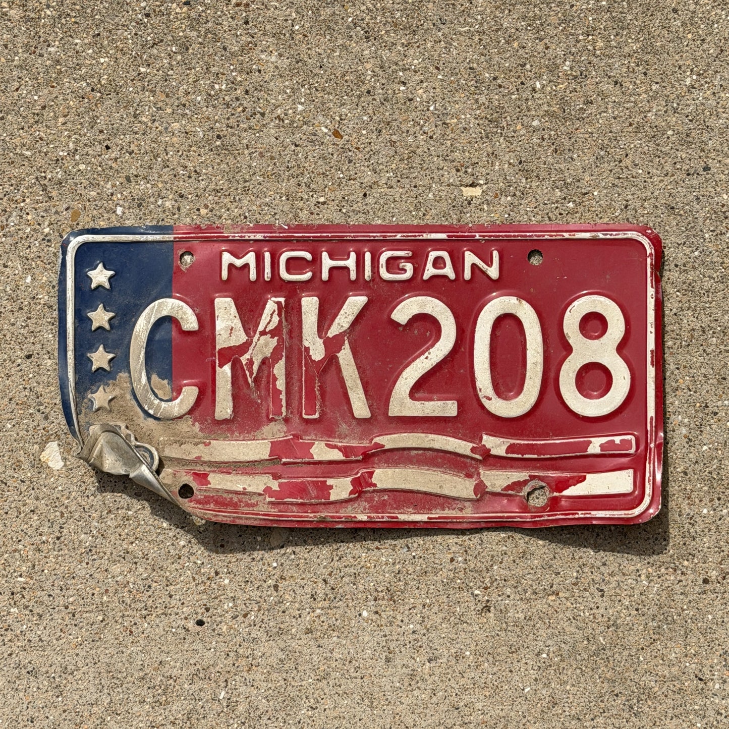 Photo of a 1976 Michigan License Plate Auto Tag Garage Decor Vintage Bicentennial CMK 208 with original patina