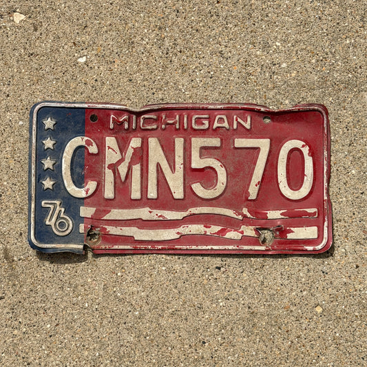 Photo of a 1976 Michigan License Plate Auto Tag Garage Decor Vintage Bicentennial CMN 570 with original patina