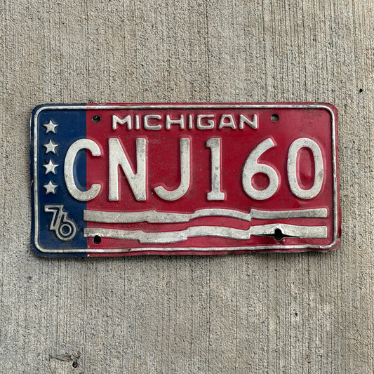 Photo of a 1976 Michigan License Plate Auto Tag Garage Decor Vintage Bicentennial CNJ 160 with original patina