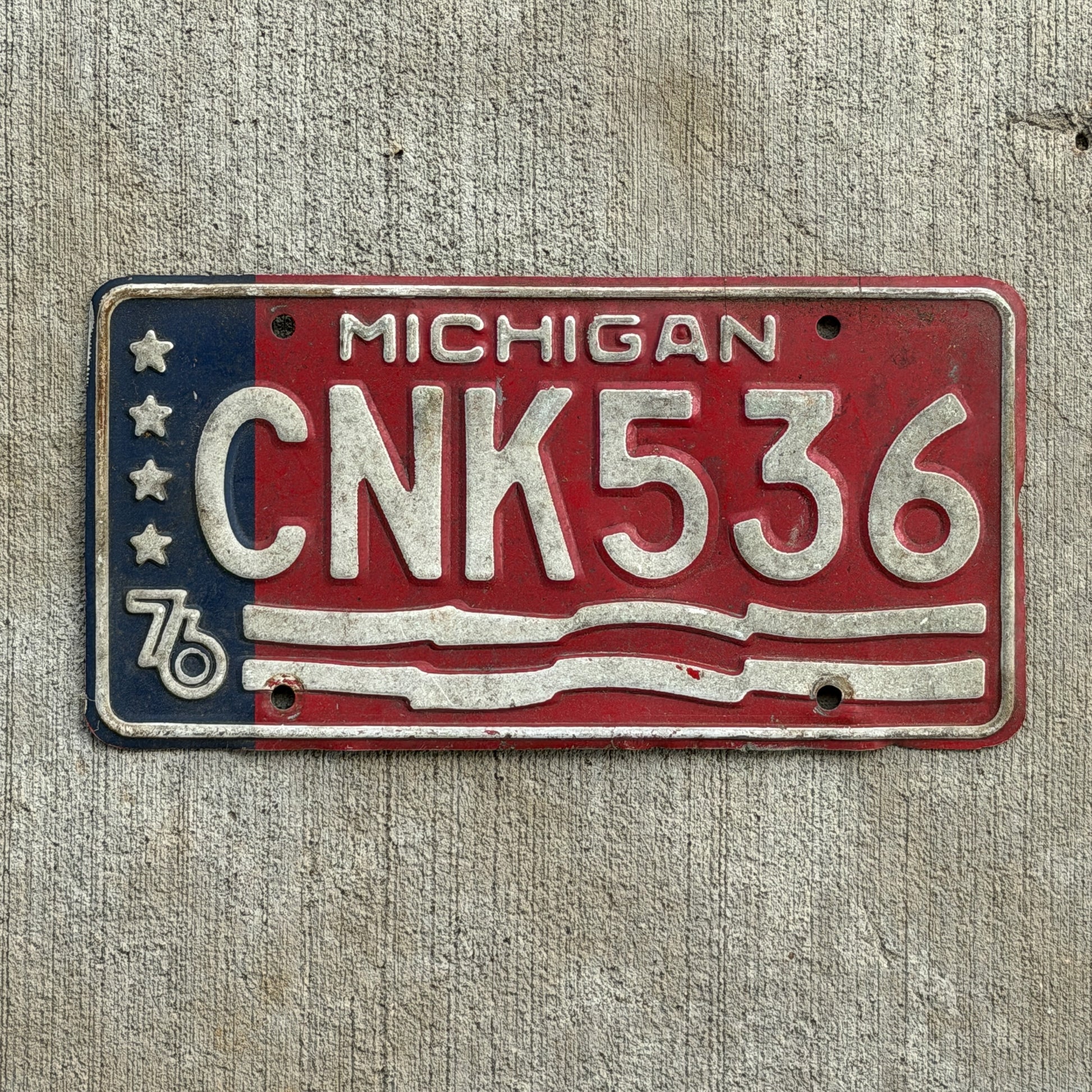 Photo of a 1976 Michigan License Plate Auto Tag Garage Decor Vintage Bicentennial CNK 536 with original patina