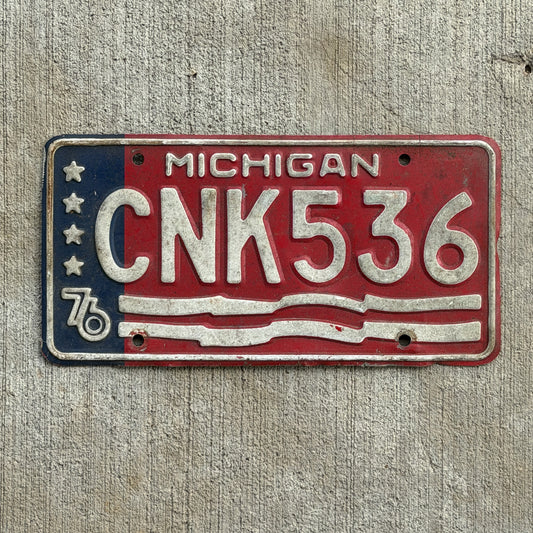 Photo of a 1976 Michigan License Plate Auto Tag Garage Decor Vintage Bicentennial CNK 536 with original patina