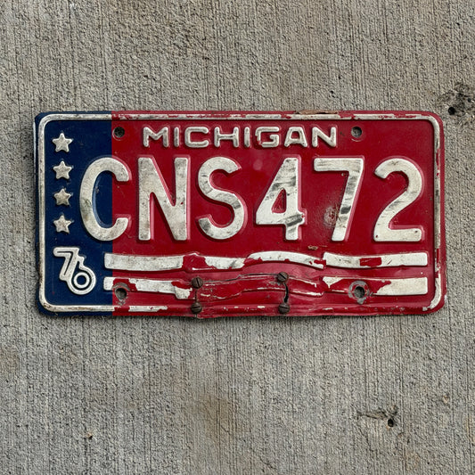 Photo of a 1976 Michigan License Plate Auto Tag Garage Decor Vintage Bicentennial CNS 472 with original patina