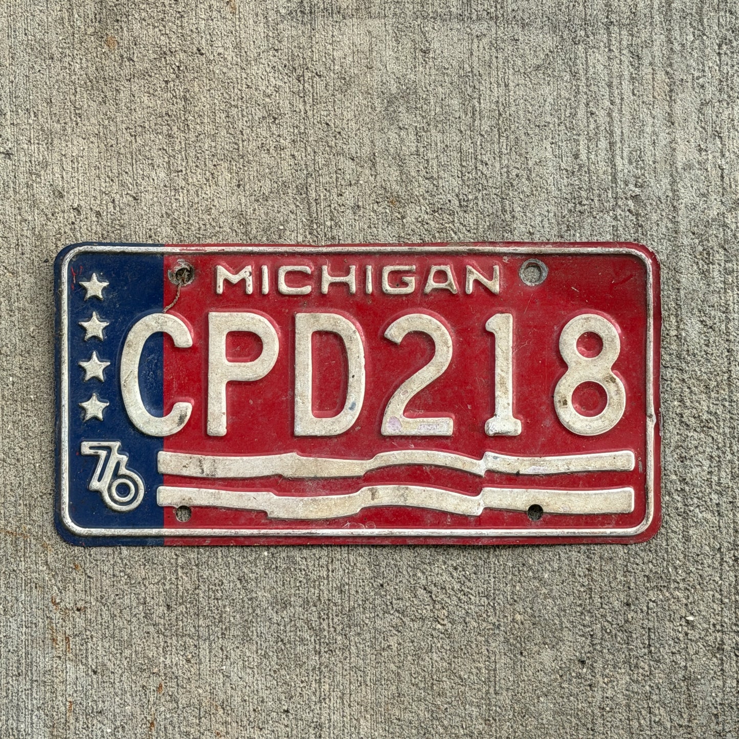 Photo of a 1976 Michigan License Plate Auto Tag Garage Decor Vintage Bicentennial CPD 218 with original patina