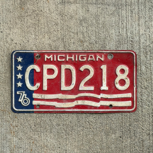 Photo of a 1976 Michigan License Plate Auto Tag Garage Decor Vintage Bicentennial CPD 218 with original patina