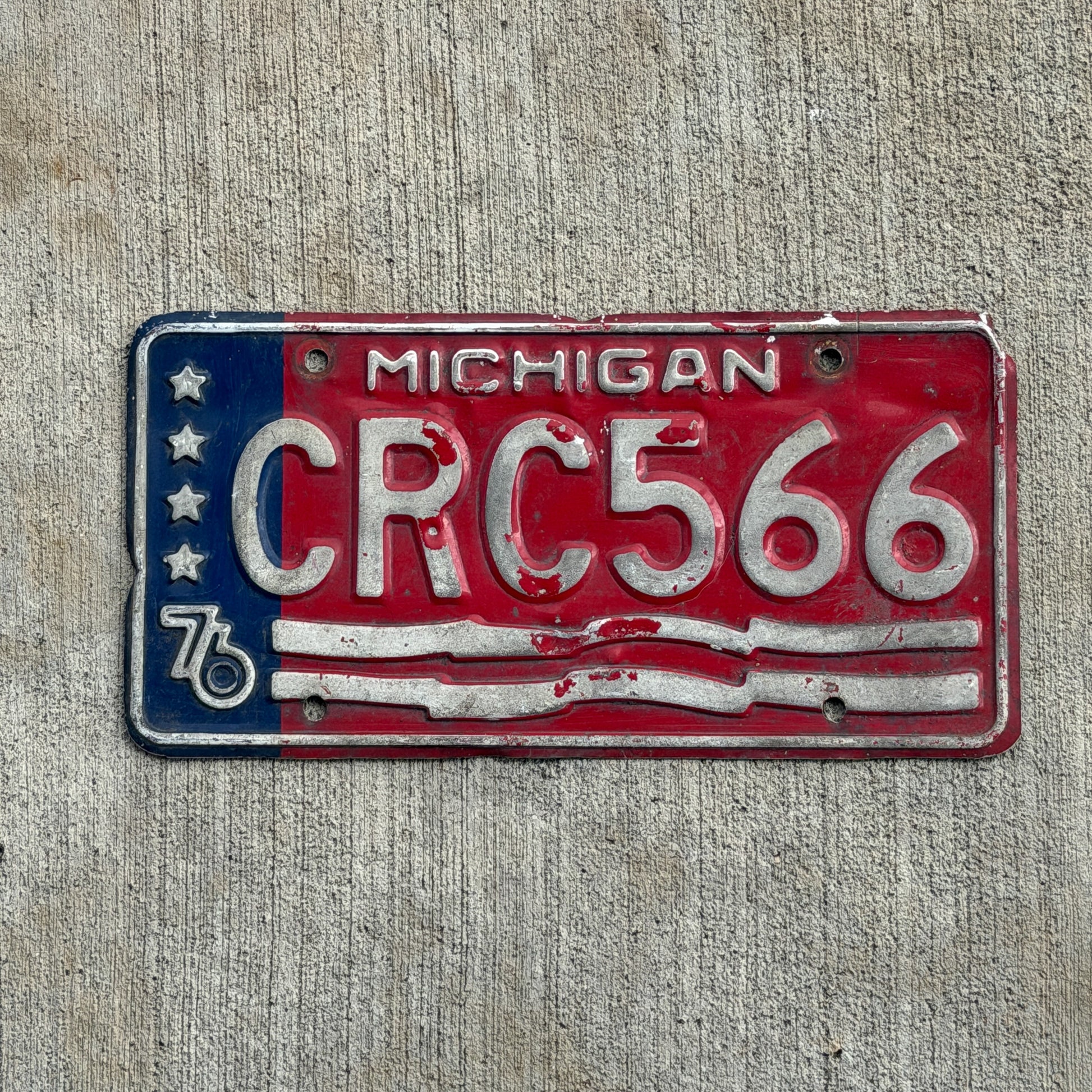 Photo of a 1976 Michigan License Plate Auto Tag Garage Decor Vintage Bicentennial CRC 566 with original patina