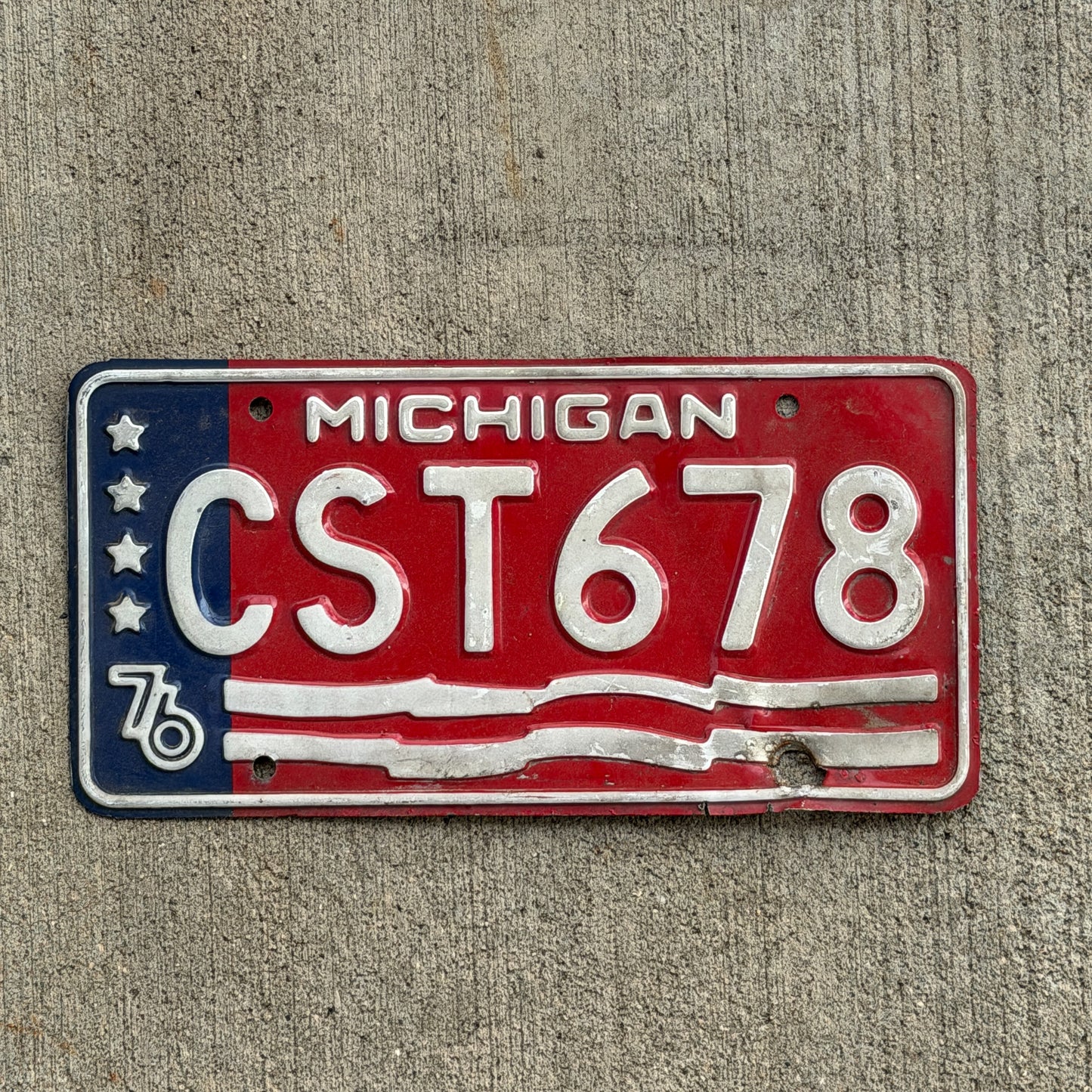 Photo of a 1976 Michigan License Plate Auto Tag Garage Decor Vintage Bicentennial CST 678 with original patina