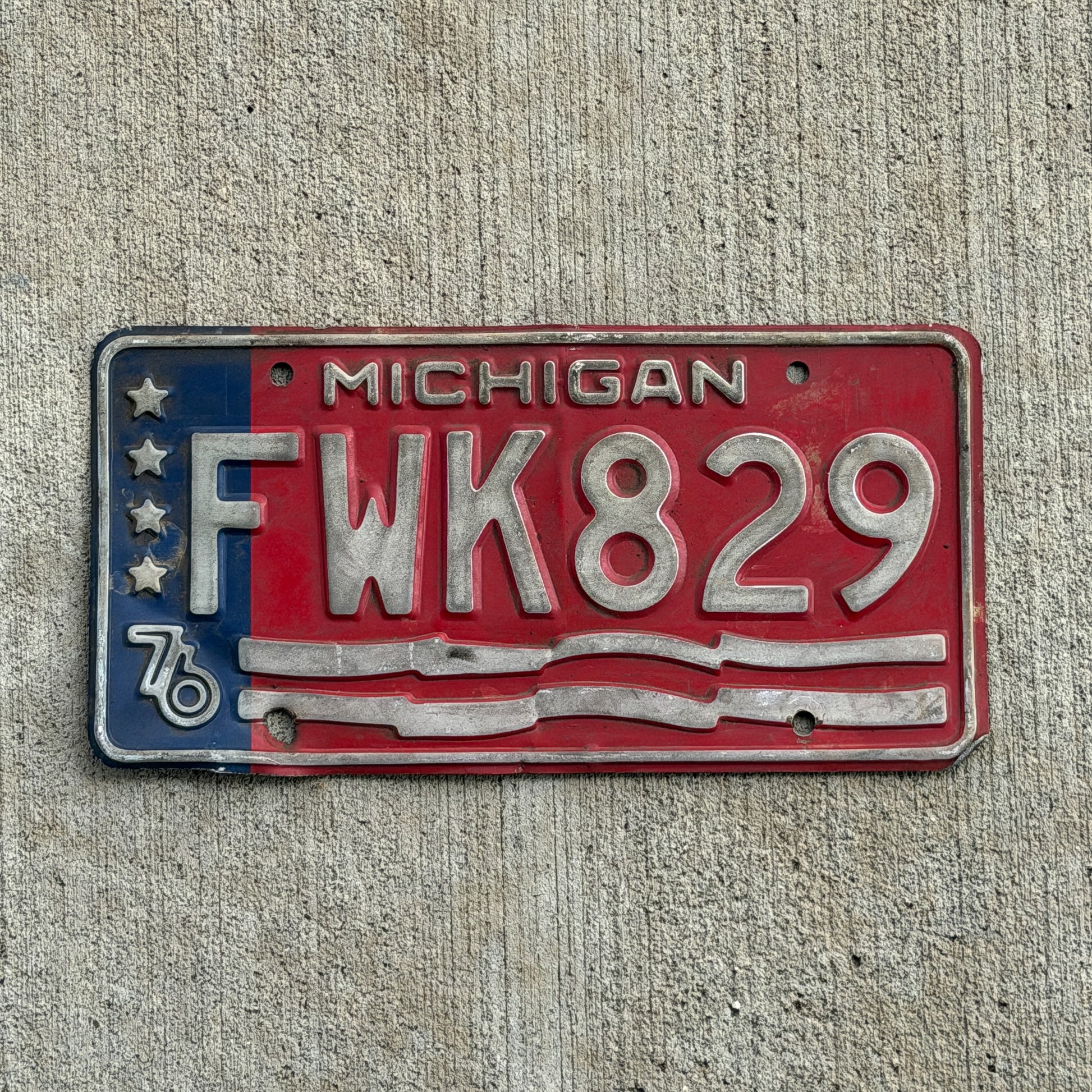 Photo of a 1976 Michigan License Plate Auto Tag Garage Decor Vintage Bicentennial FWK 829 with original patina