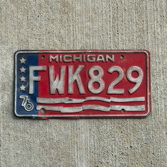 Photo of a 1976 Michigan License Plate Auto Tag Garage Decor Vintage Bicentennial FWK 829 with original patina