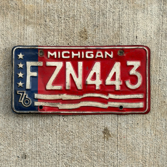Photo of a 1976 Michigan License Plate Auto Tag Garage Decor Vintage Bicentennial FZN 443 with original patina