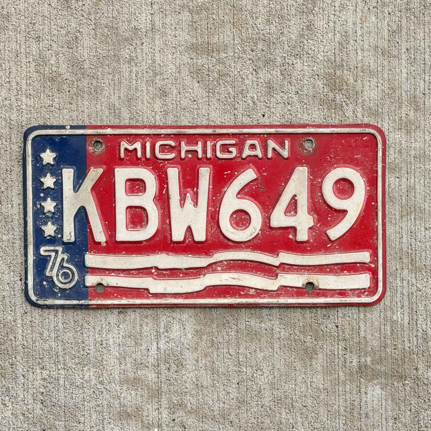 Photo of a 1976 Michigan License Plate Auto Tag Garage Decor Vintage Bicentennial KBW 649 with original patina