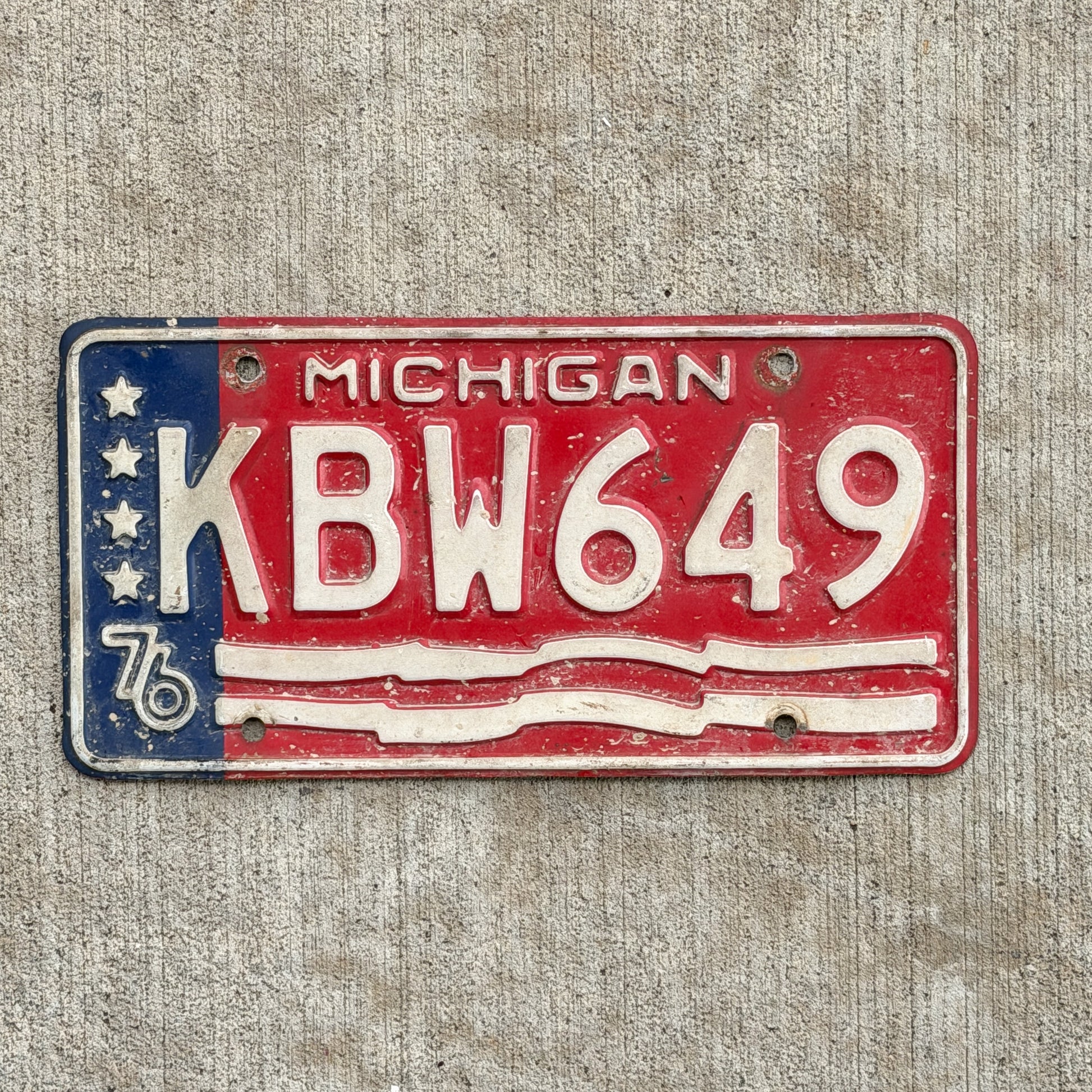 Photo of a 1976 Michigan License Plate Auto Tag Garage Decor Vintage Bicentennial KBW 649 with original patina